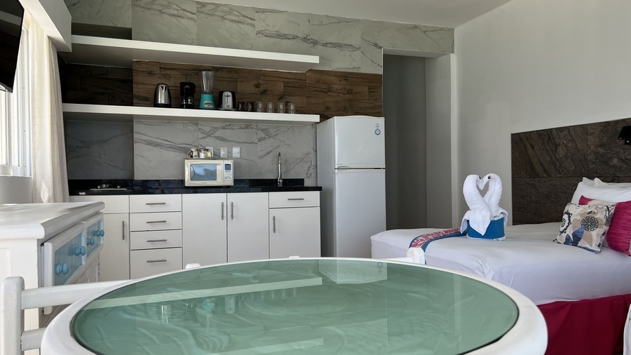 a hotel room with a refrigerator and a microwave