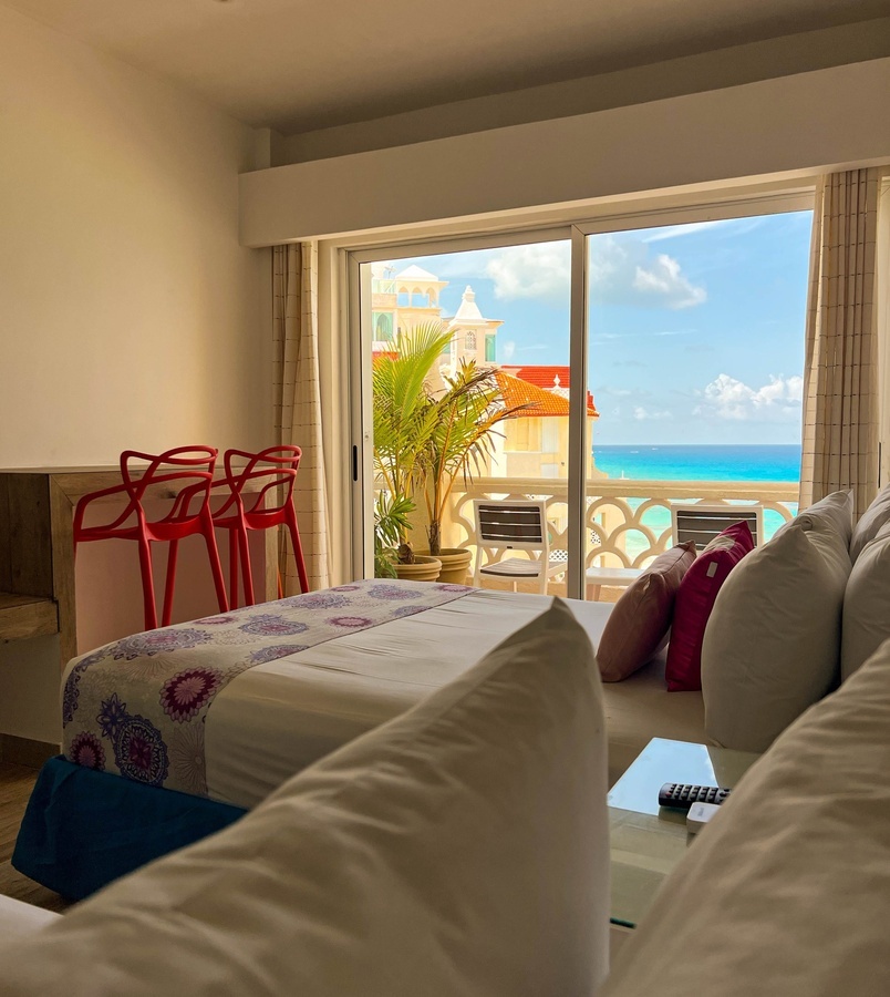 a hotel room with a view of the ocean