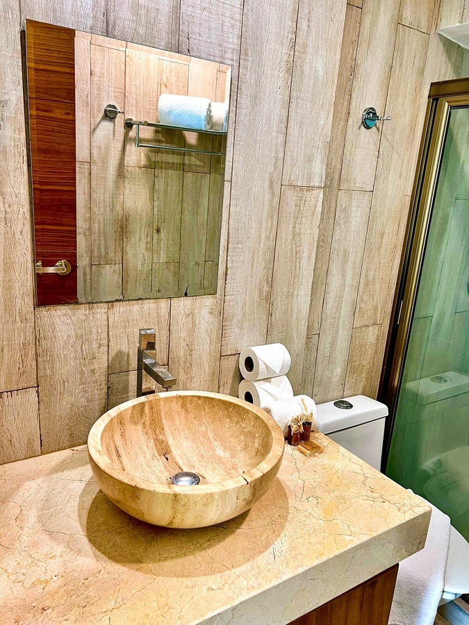 a bathroom with a wooden sink and toilet
