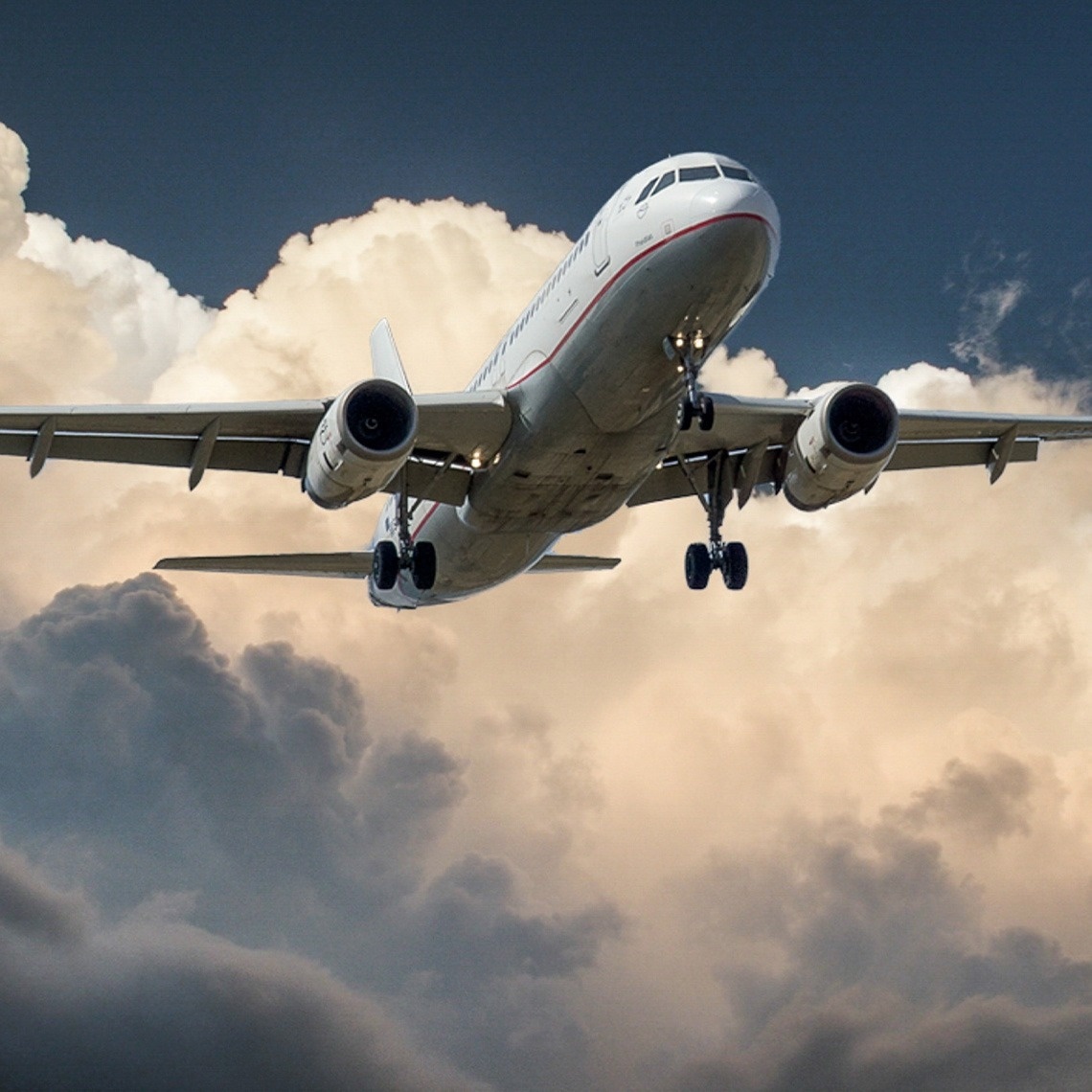 an airplane is flying through a cloudy sky