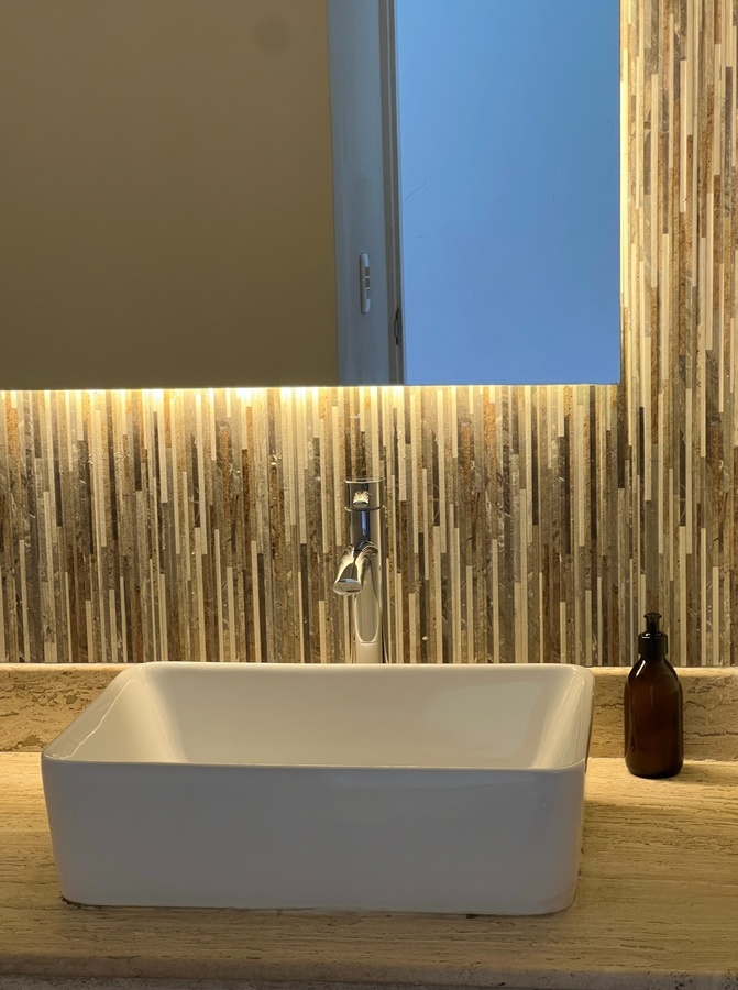 a bathroom sink with a soap dispenser next to it