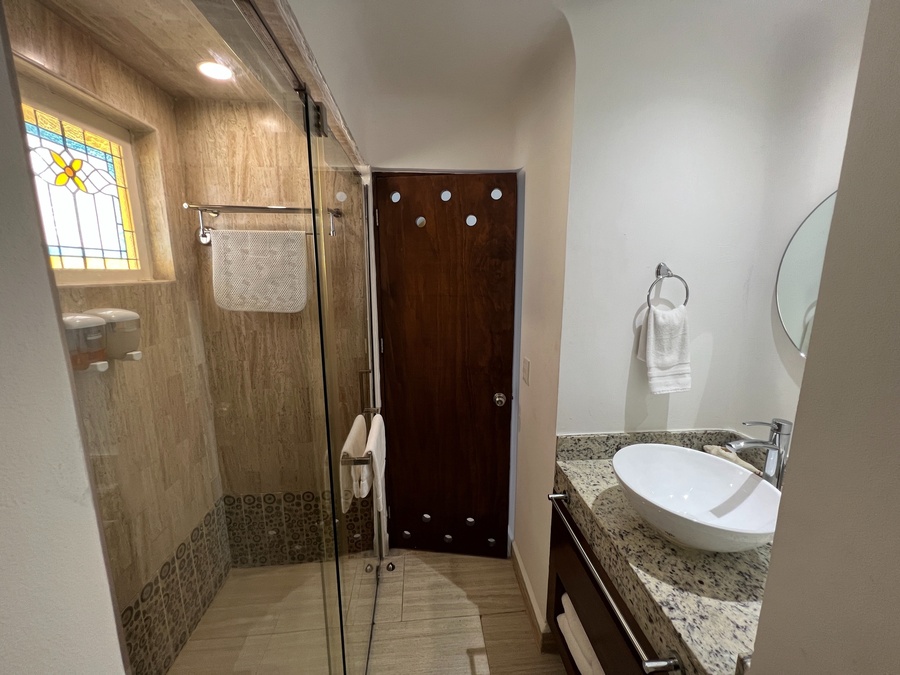 a bathroom with a sink and a walk in shower