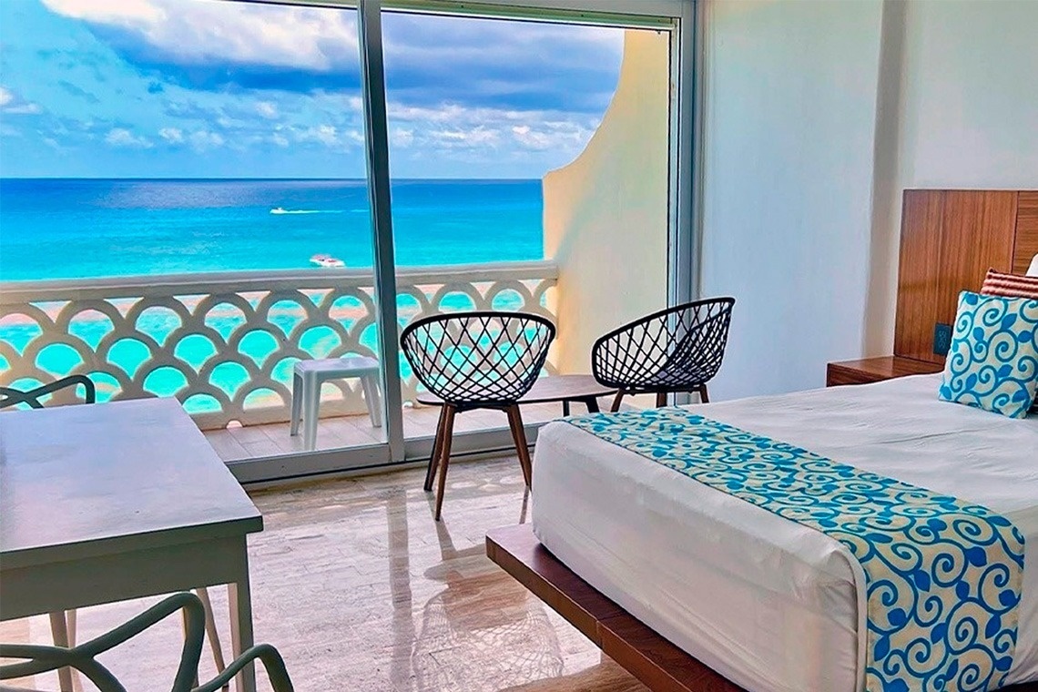 a hotel room with a view of the ocean