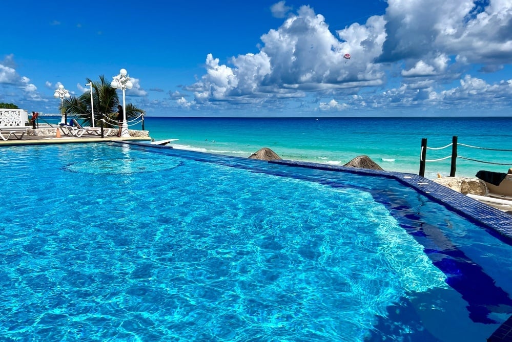 a large swimming pool with a view of the ocean