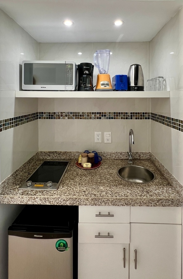 a kitchen with a samsung microwave and a hisense refrigerator