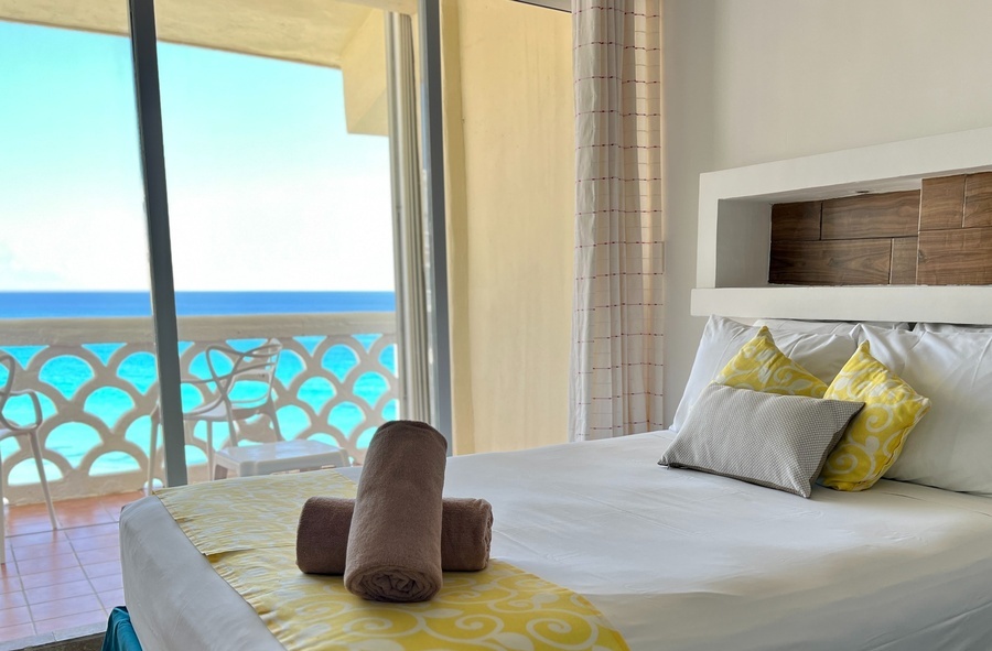 a hotel room with a view of the ocean