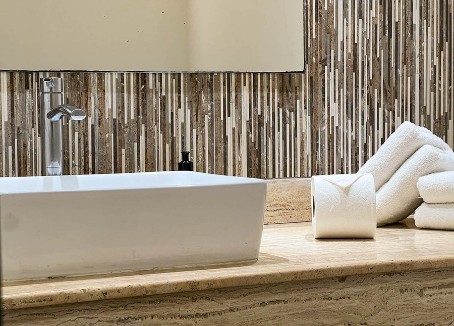 a bathroom with a sink and towels on the counter