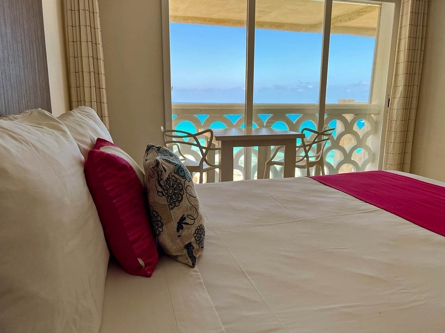 a hotel room with a view of the ocean