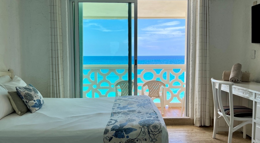 a hotel room with a view of the ocean