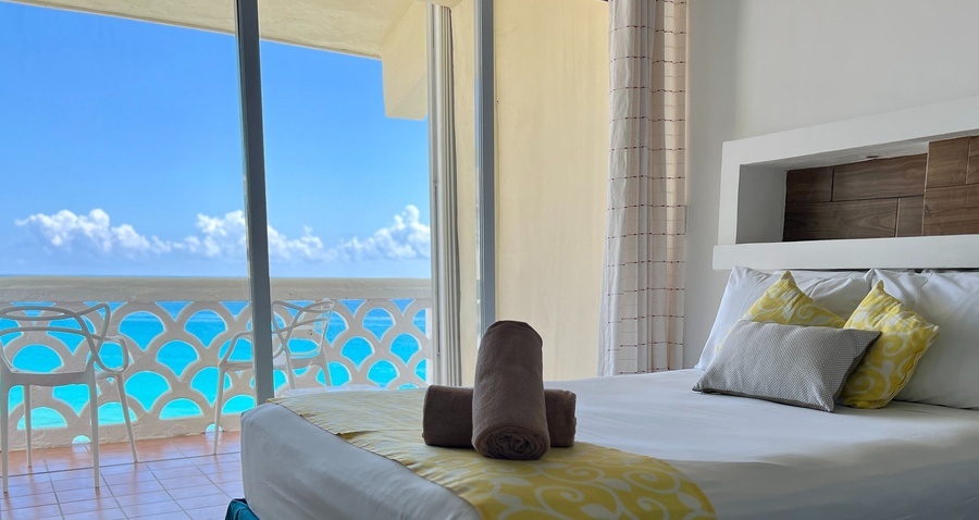 a hotel room with a view of the ocean