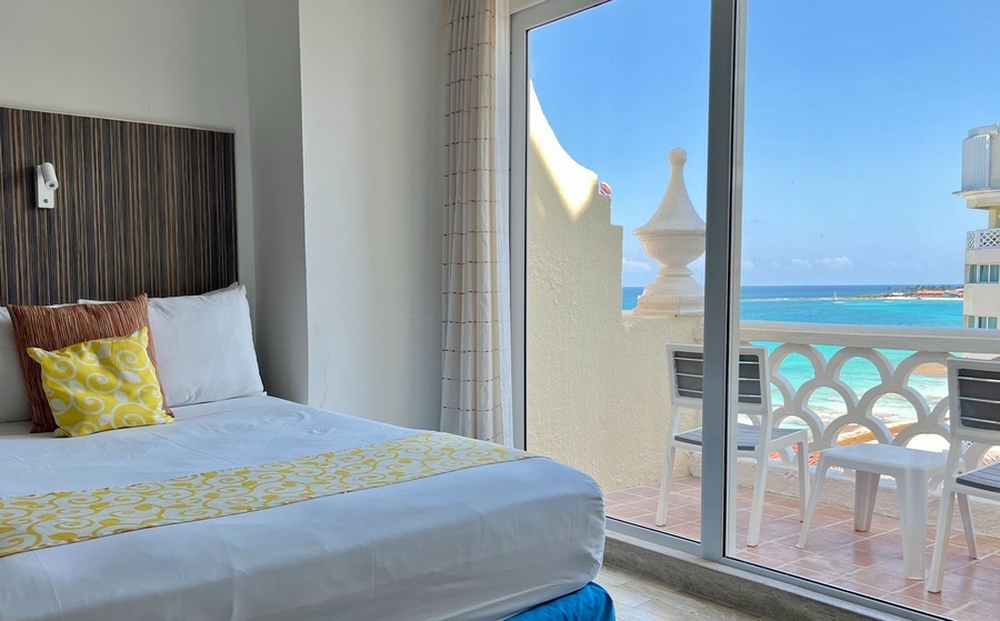 a hotel room with a view of the ocean