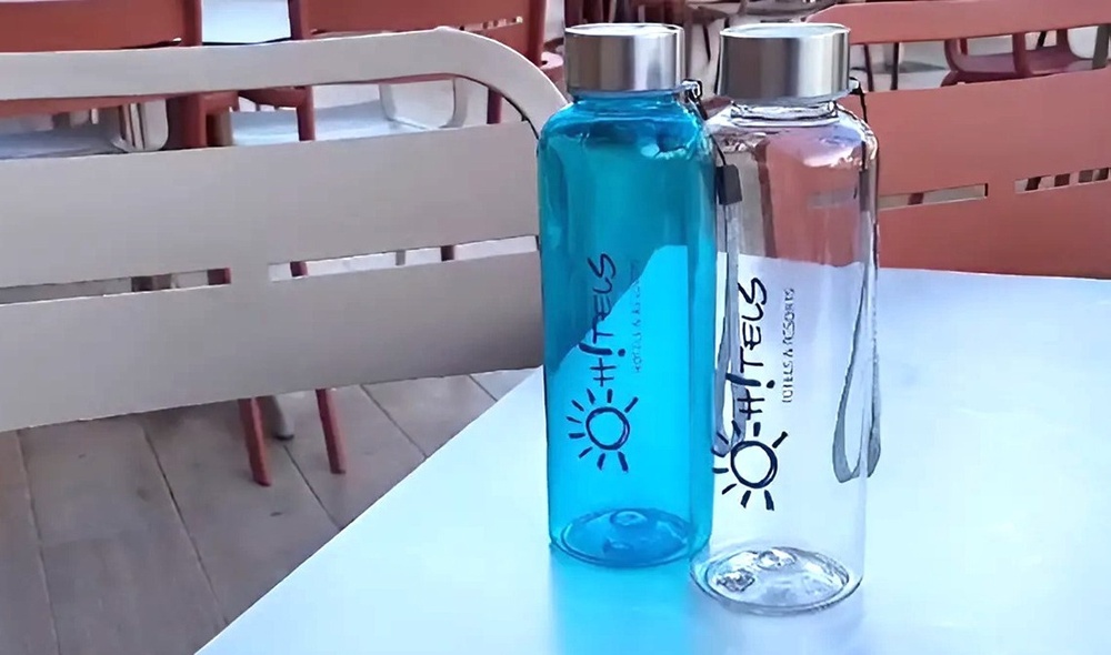 a blue and a white water bottle with a sun on it