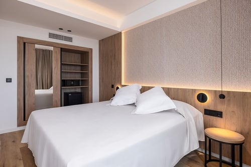 una habitación de hotel con una cama y una mesita de noche