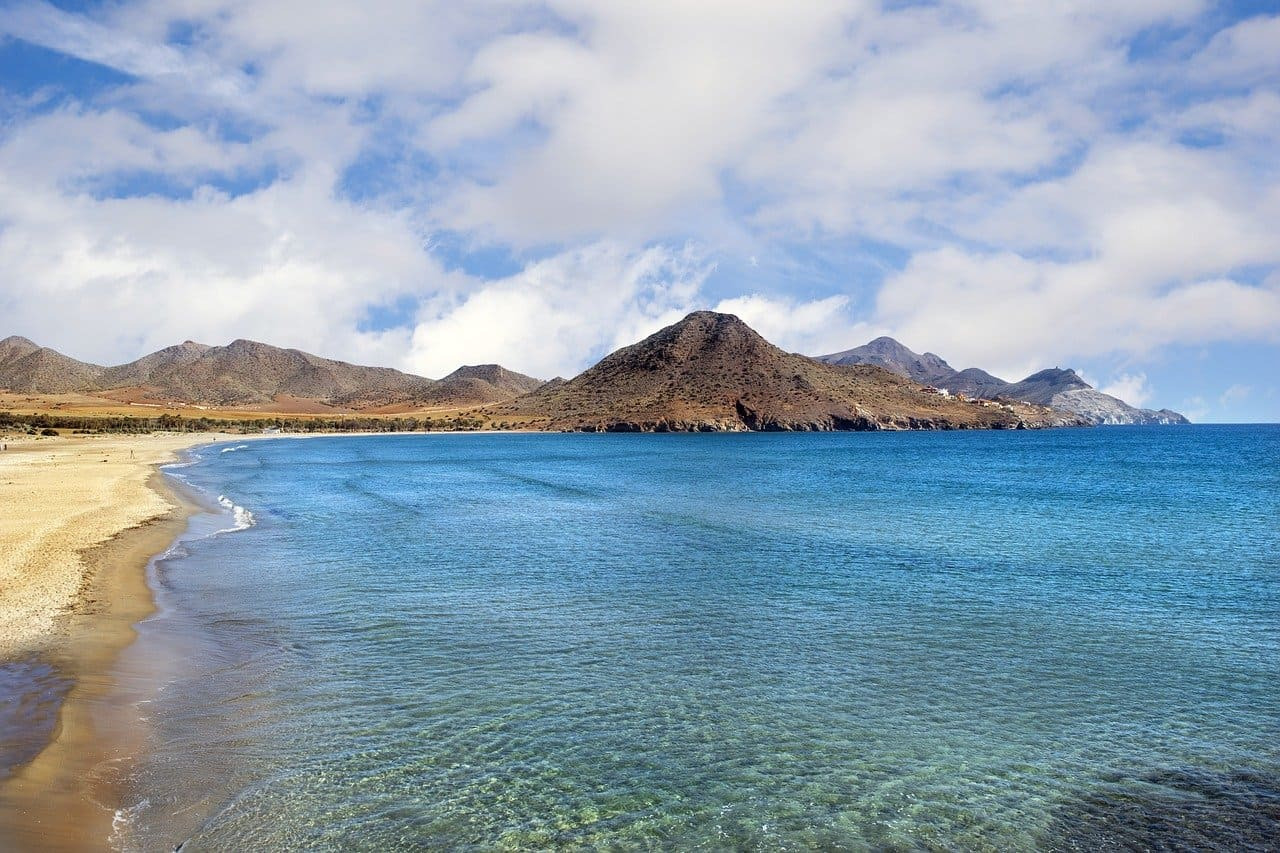 Ohtels: Scenic coast with striking rock formation and sunset sky, perfect for your stay.