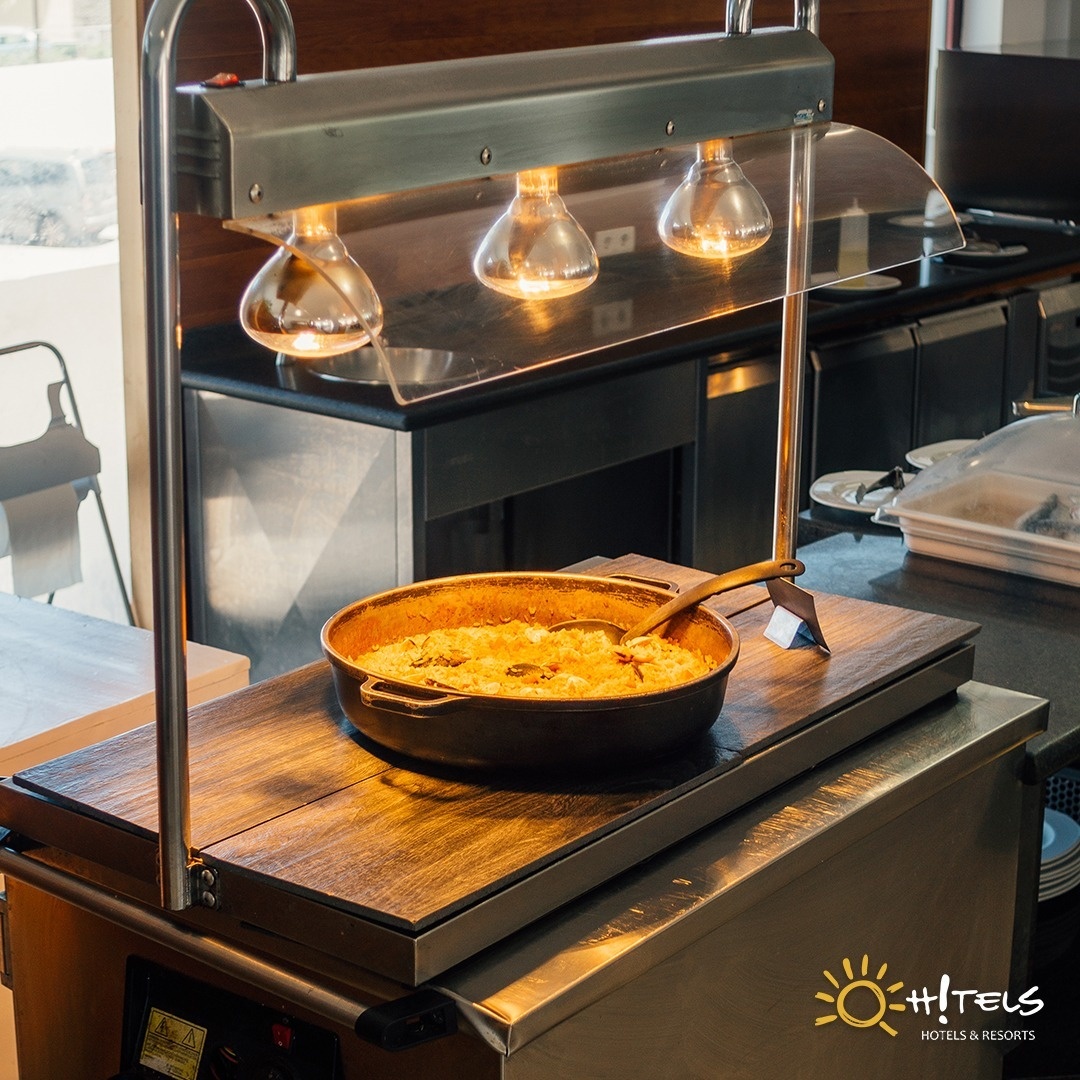 a frying pan with a spoon in it sits on a tray with the words hotels hotels & resorts on the bottom