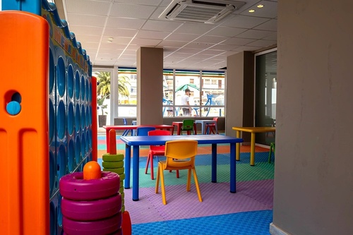 a children 's play area with tables and chairs