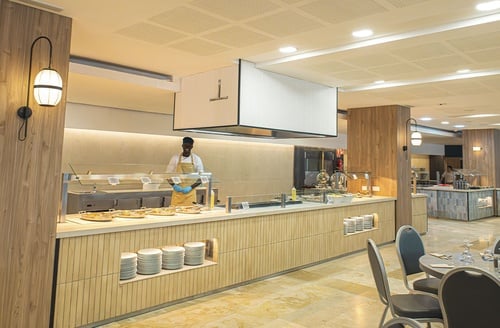 Buffet del Hotel Perelló | Ohtels Les Oliveres, con cocinero sirviendo platos calientes.