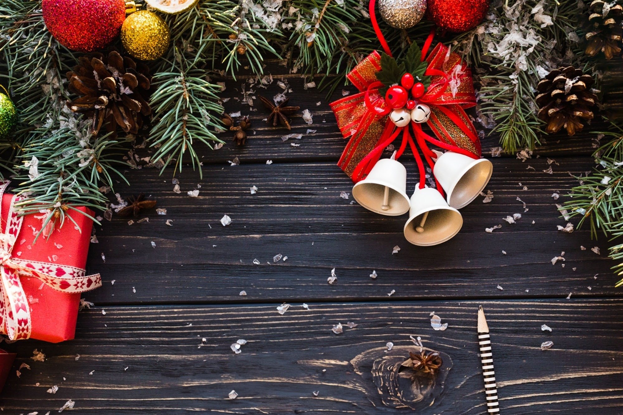 a person is holding a brown envelope with christmas decorations around it