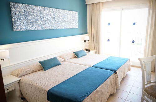 Chambre double confortable avec lits jumeaux, décor bleu et blanc. Hôtel à Cabo de Gata.