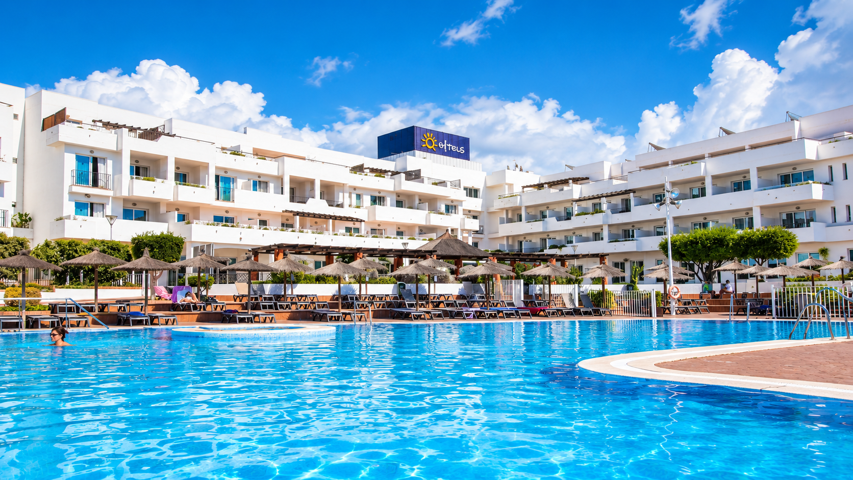 Ohtels: Corporativa, resort pool with white buildings and clear blue sky.