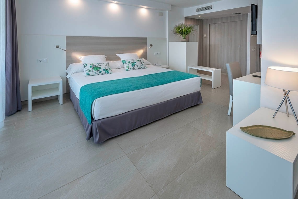 una habitación de hotel con una cama y un escritorio