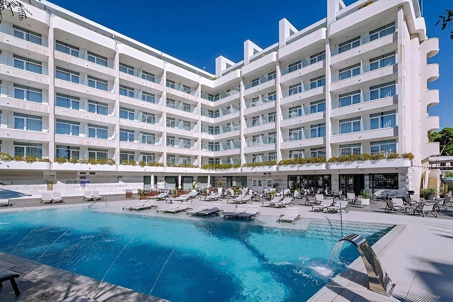 a swimming pool with a wooden deck and stairs