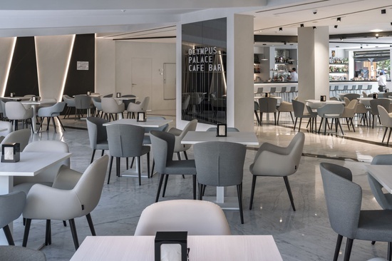 a restaurant called olympus palace cafe bar with tables and chairs