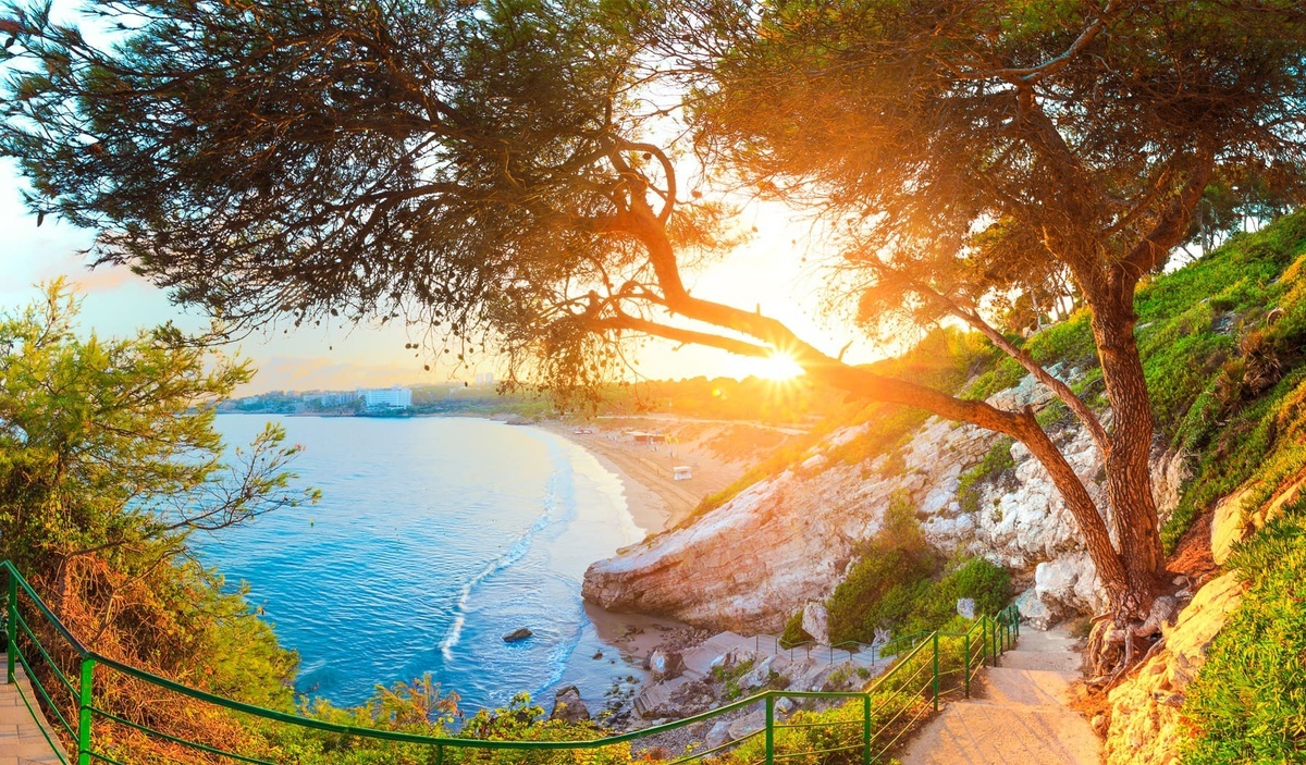 escaleras que conducen a una playa al atardecer