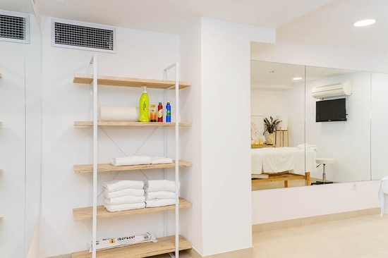 a shelf with towels and a bottle of nutrex on it