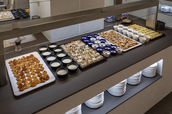 a buffet line with a variety of desserts and appetizers