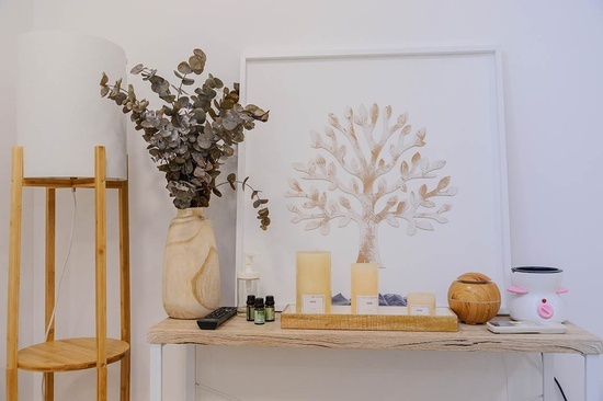 a table with a picture of a tree and candles on it