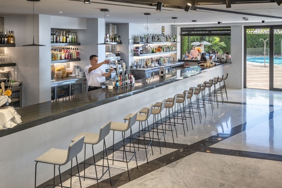 a bartender prepares a drink at a hotel bar