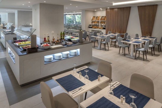 a restaurant with tables and chairs and a buffet