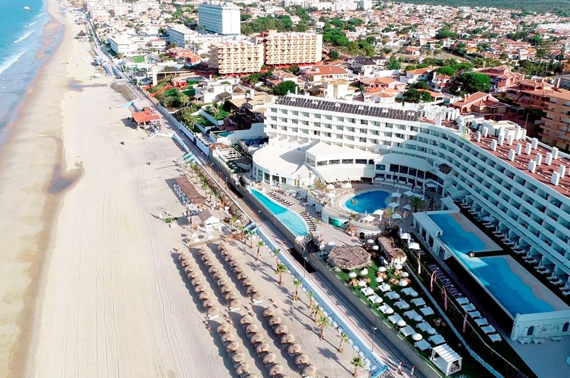 an aerial view of a hotel on the beach