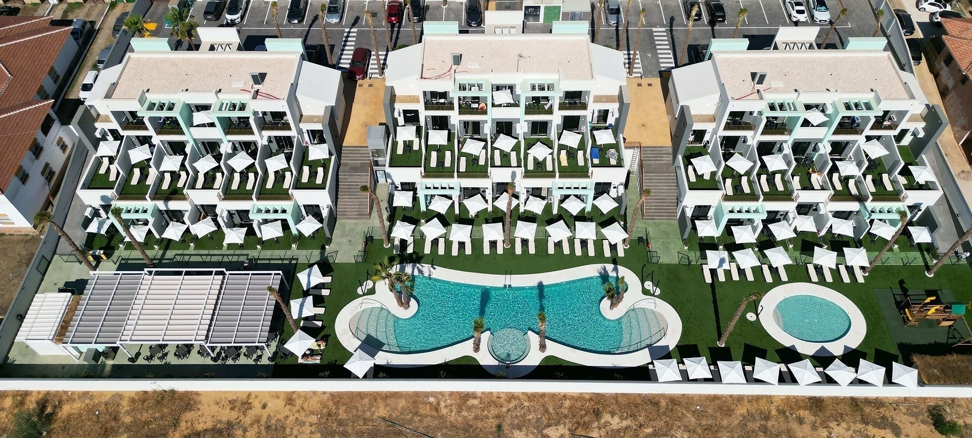 an aerial view of a hotel with a large pool