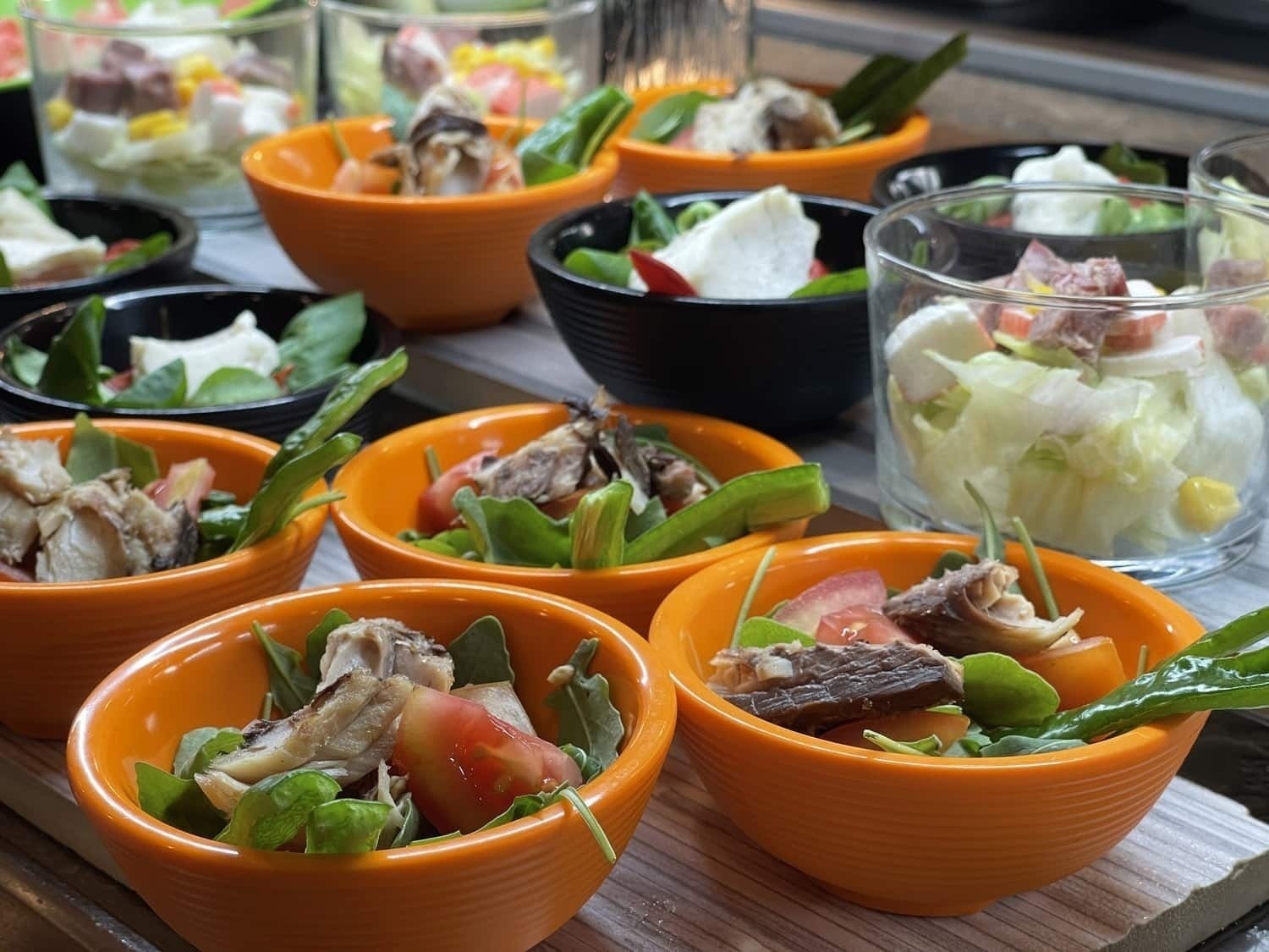 a variety of salads in small bowls on a table