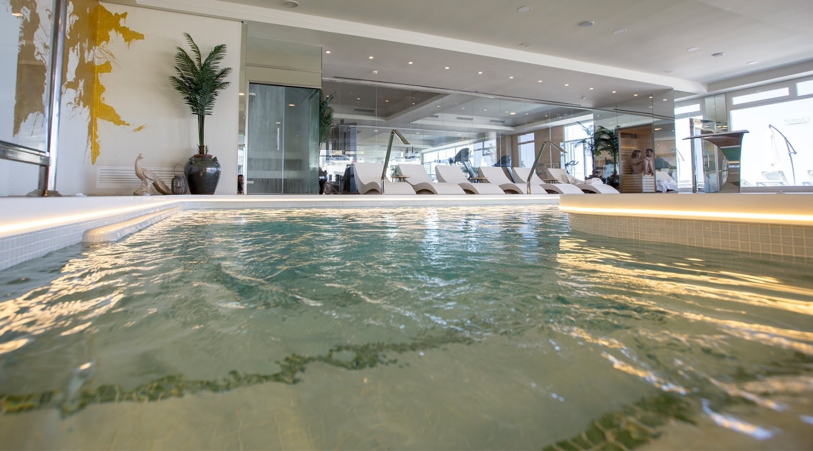 a large swimming pool with a map of the world on the wall behind it