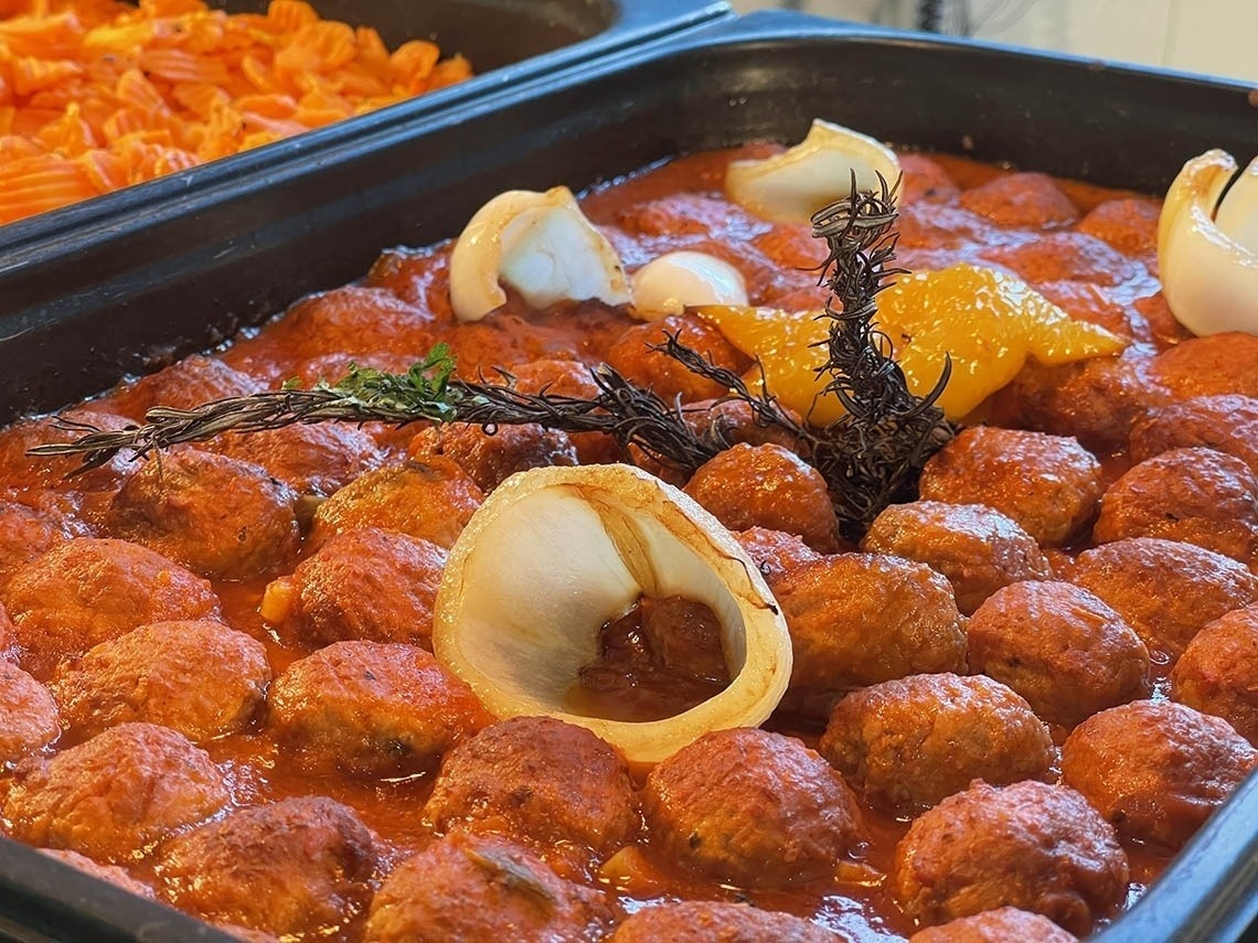a casserole dish filled with meatballs and sauce
