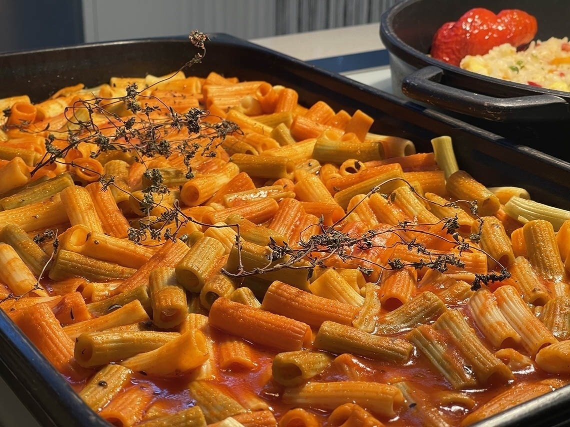 a casserole dish filled with pasta and tomato sauce