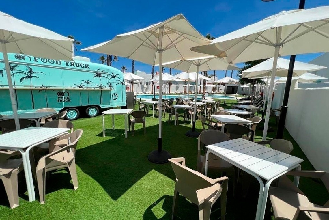 a food truck with tables and chairs in front of it