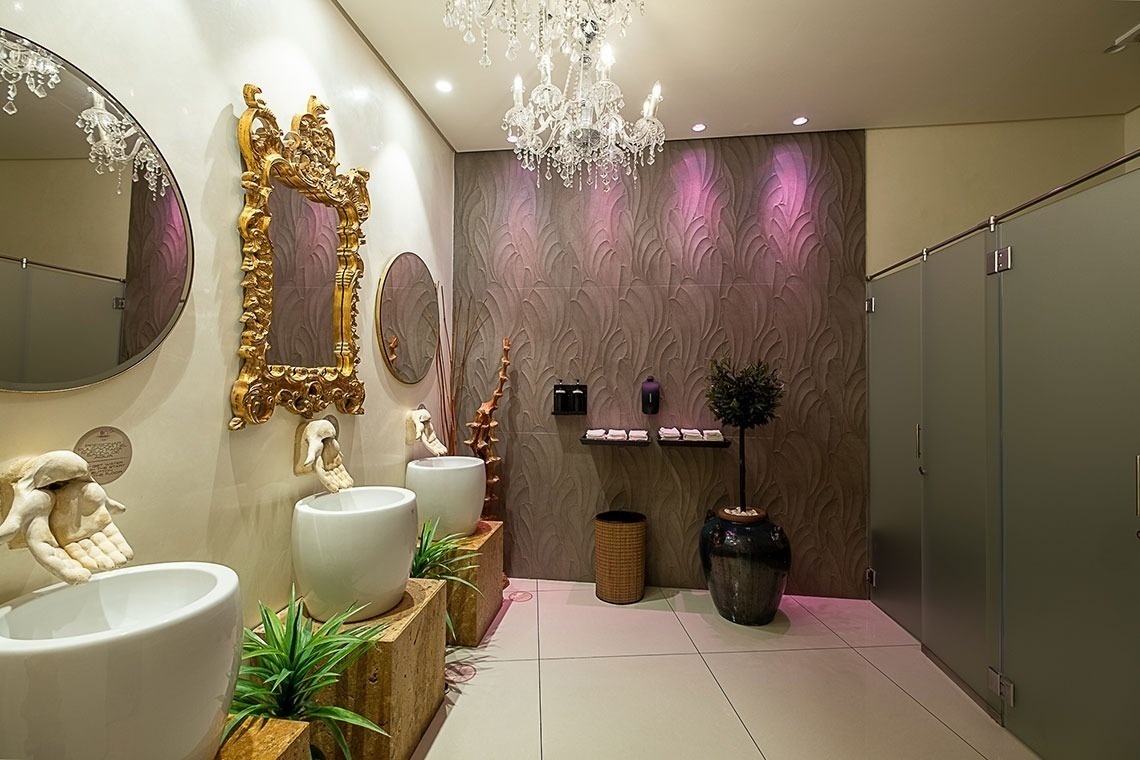 a bathroom with two sinks a mirror and a chandelier