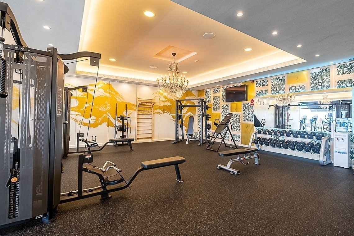 a gym with a chandelier hanging from the ceiling