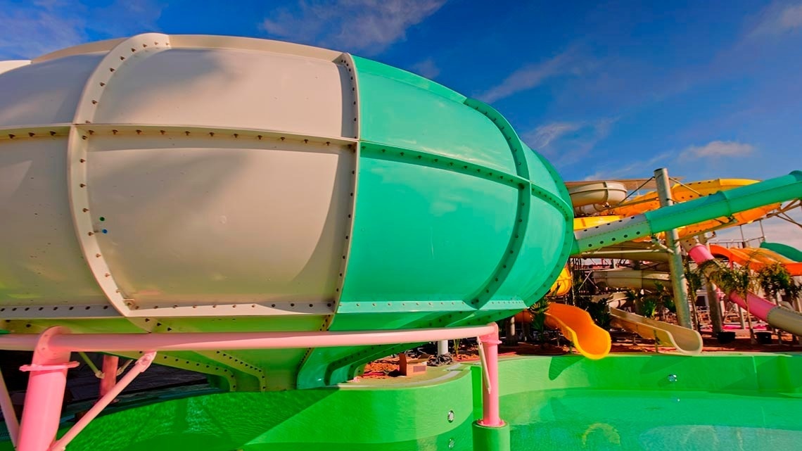 a water park with a green and white slide