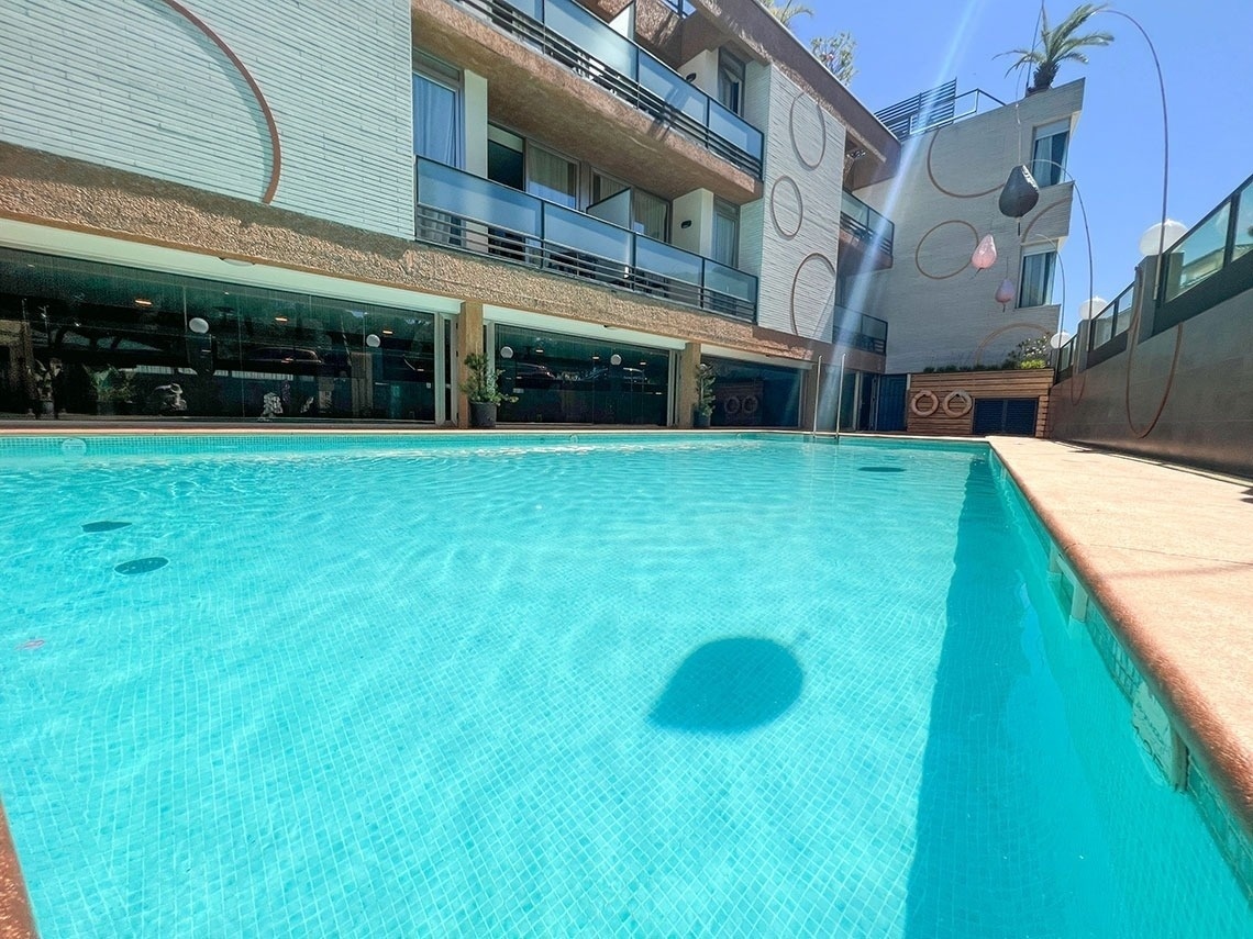 a large swimming pool in front of a building that says ' ao ' on it