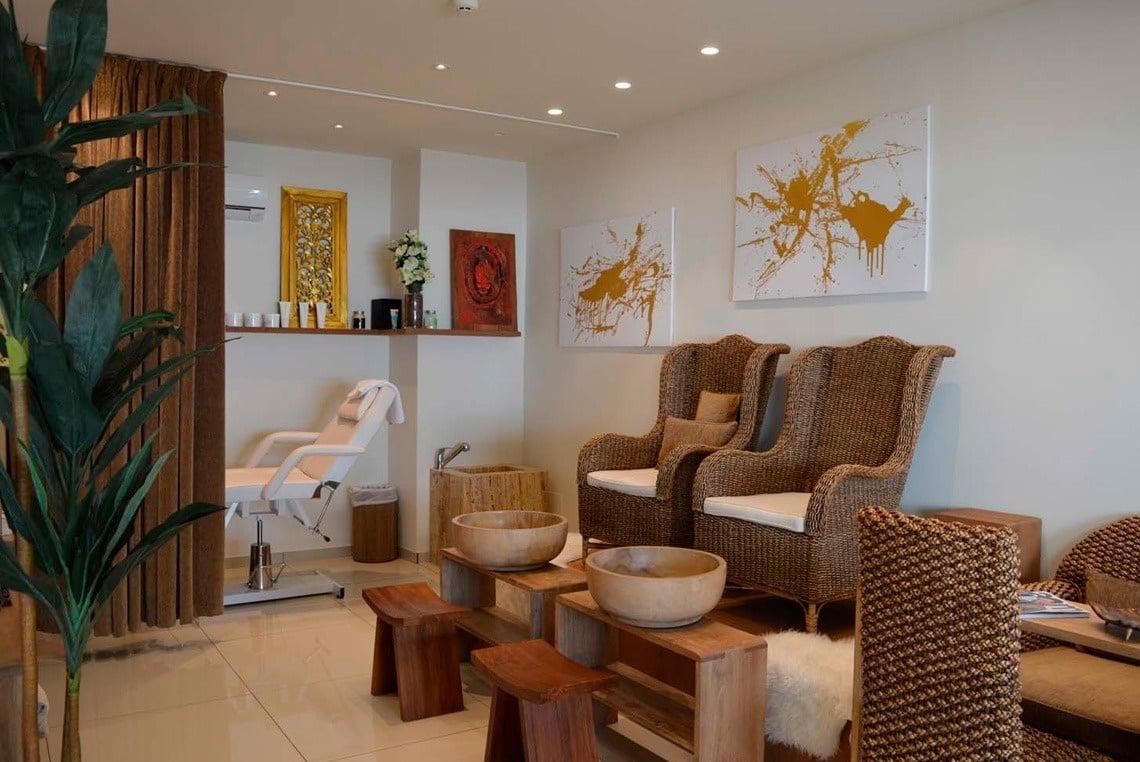 a room with wicker chairs and wooden bowls in it