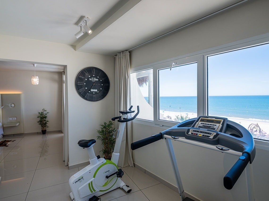 a treadmill sits next to an exercise bike in a room