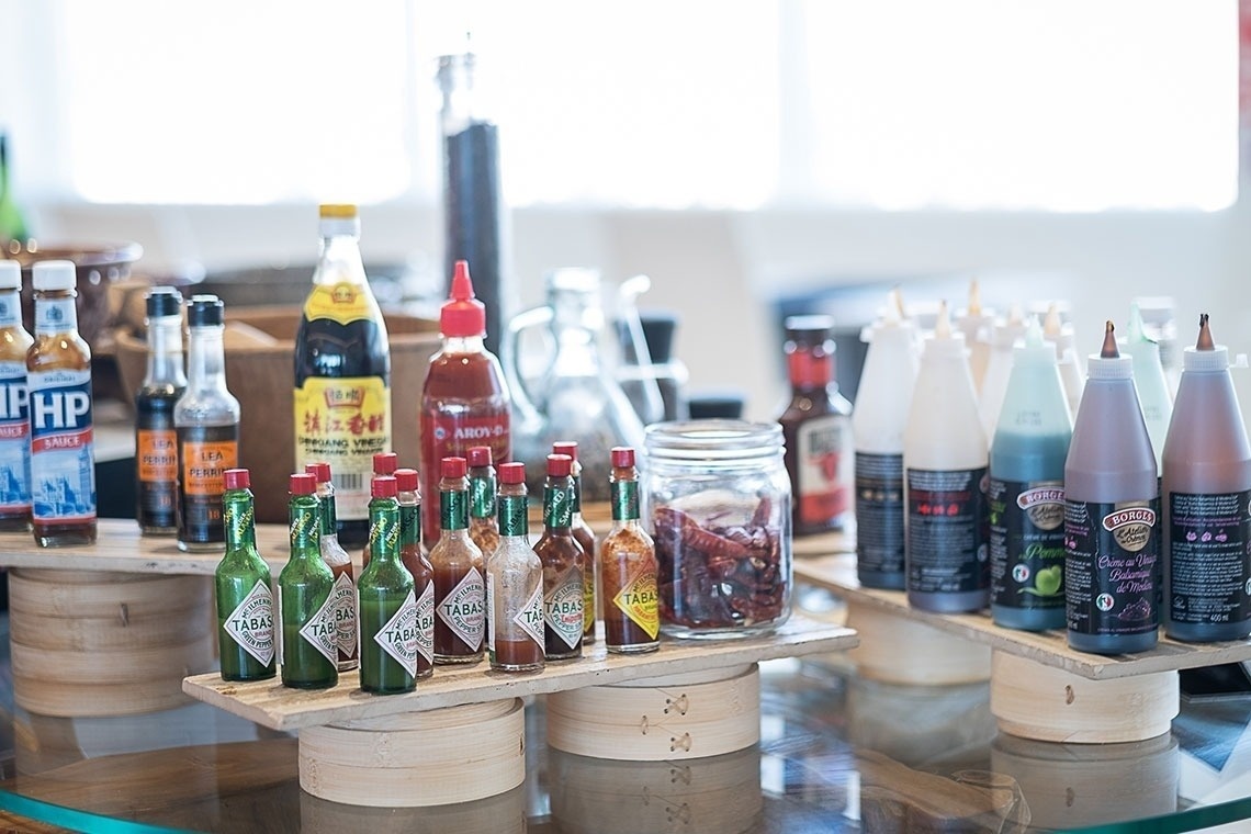 several bottles of tabasco are on display on a table