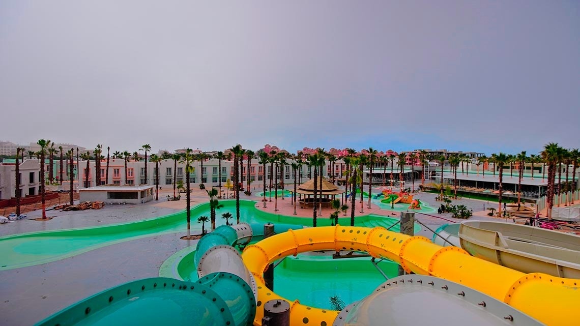 a water park with lots of slides and palm trees