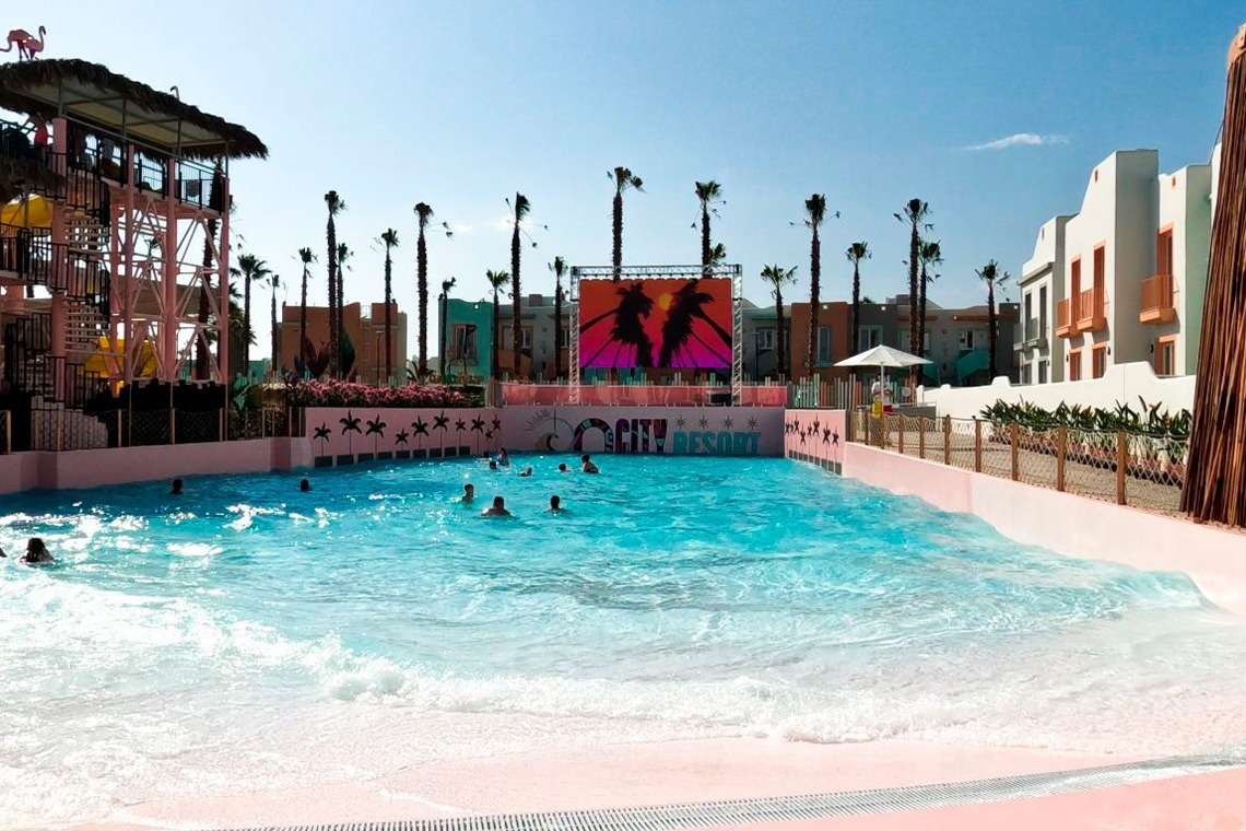 people are swimming in a pool that says city resort