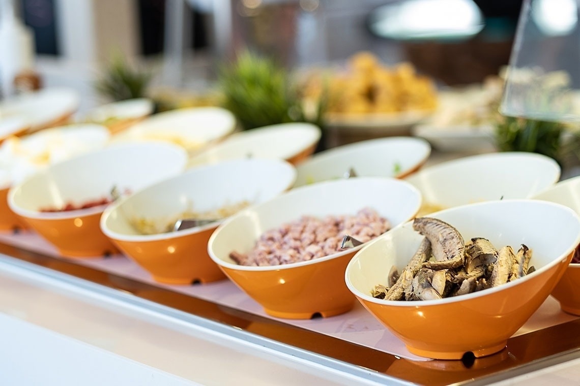 several bowls of food are lined up on a table